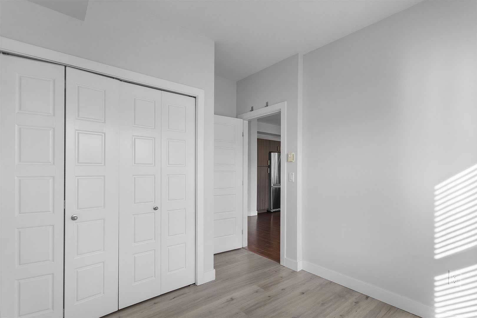Living area with wide plank flooring and patio access