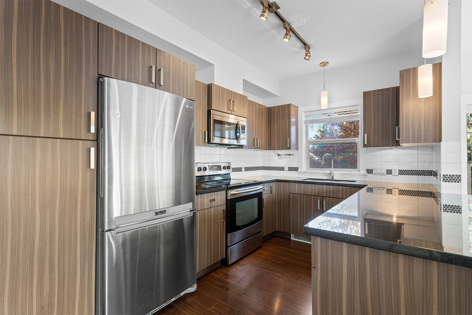 Kitchen detail with cabinetry and tile backsplash